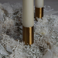 gold candle stick on xmas wreath with candles